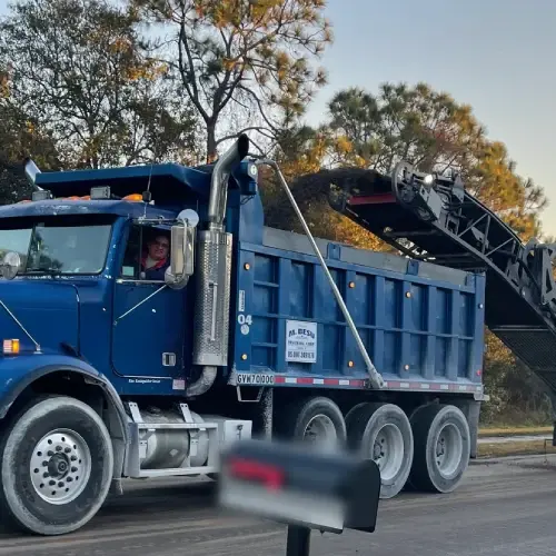 Blue dump Truck Material hauling service